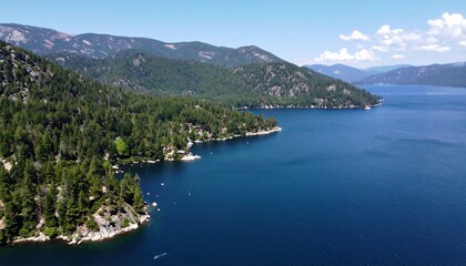 Fototapeta premium Scenic lake surrounded by forested mountains