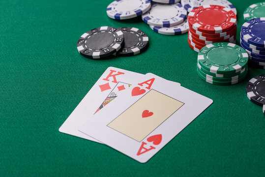 Playing blackjack or baccarat card game in casino with chips, bets and risk. Cards and chips on felt