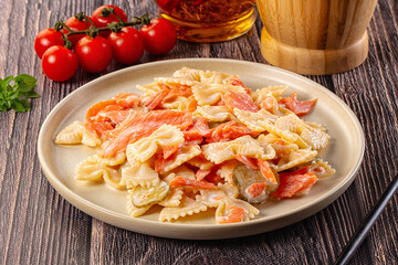 Italian pasta farfalle with salmon
