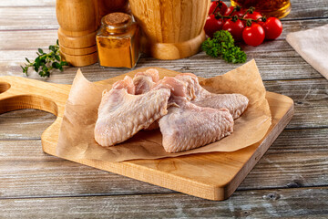Fresh raw chicken wings over board