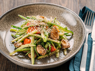 Delicious pork, veal or beef salad with cucumber in asian style with amaranth popcorn or popped amaranth replaceable sesame. Idea salad recipe for healthy menu. Vibrant bright meat salad with cucumber