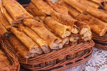 Freshly baked pastry arranged to baskets. Pastry are golden brown with various fillings