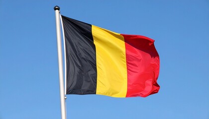 The Flag of Belgium Waving against a Blue Sky