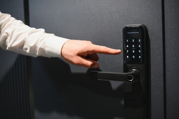 Businessman opening door using digital keypad lock