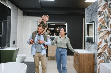 Obraz premium Family choosing bathroom fixtures in plumbing store