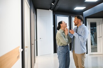Fototapeta premium Couple choosing interior doors in a furniture store