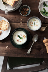 Celeriac Soup with toasted walnuts and fried sage leaf. Healthy vegetarian meal concept.