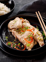 Sous Vide Chicken with spices. Boiled chicken sous-vide on black plate. Sous-vide is culinary method of long-term cooking