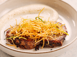 Beef or pork steak with shoestring fries onion and potatoes puree. Restaurant style plating beefsteak. Food and cuisine concept. Delicious pork steak. BBQ rib beefsteak or tender pork steak