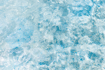 The clear blue water displays a mesmerizing texture as sunlight dances on its surface. Gentle...