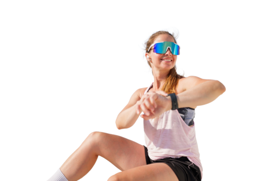 Active woman enjoying while checking fitness tracker on her wrist in sporty attire