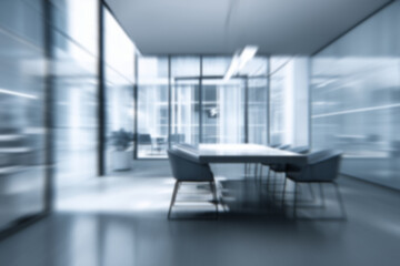 Fototapeta premium Blurred abstract background with conference room in bustling business center hall, with businessmen and people captured in motion blur through a long exposure technique. Work atmosphere. 