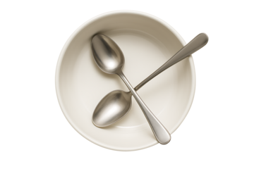 Top view of silver metal spoons in a light cream bowl isolated on transparent background
