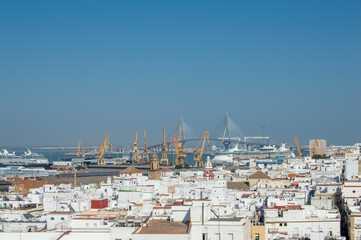 Port harbor cranes and maritime logistics infrastructure with La Pepa cable-stayed bridge in Cadiz Spain © Sara