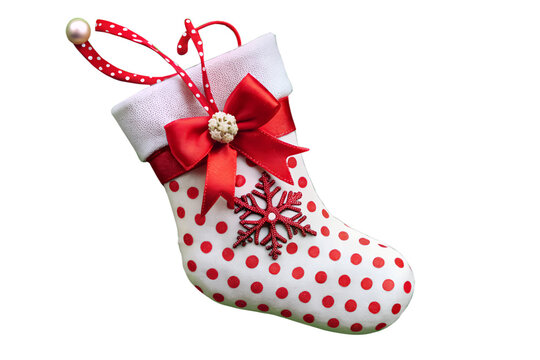 Festive christmas stocking ornament isolated on transparent background, adorned with red polka dots, a bow, and a snowflake for holiday cheer