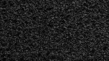 Black rough textured surface background for web banner page template design. creates oppressive and somewhat gloomy mood.