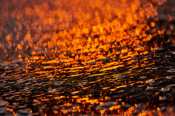 Gilded Ripples Dance Upon Molten Waters