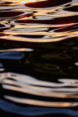 Gilded Ripples Dance Upon Molten Waters