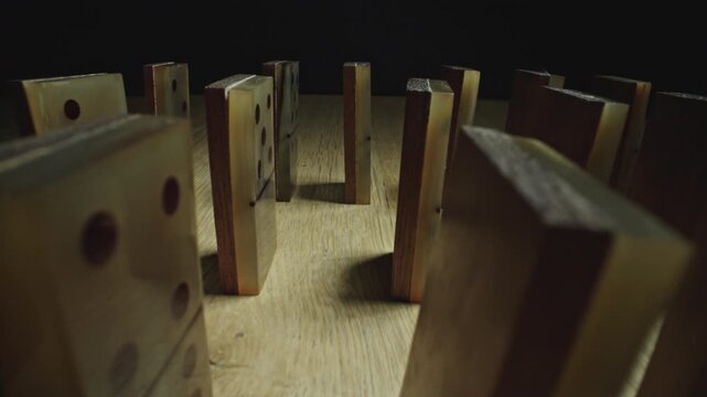 Close-Up of Domino Tiles Before Toppling in Dark Setting
