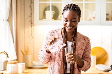 Thirsty Black Woman Drinking Water In Kitchen, Pouring Healthy Liquid From Jug To Glass, Happy...