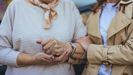 Elderly Woman Holding Hands With Caregiver in a Warm Embrace