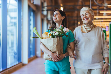 Caregiver and Elderly Woman Enjoying Shopping Together in Grocery Store