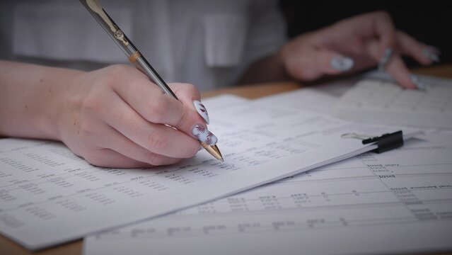 A group of friends engages in productive discussions while reviewing important documents on a sunny summer day, creating a lively atmosphere in nature. - Powered by Adobe