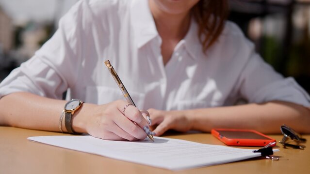 Group of business individuals enjoys a summer meeting in nature, fostering teamwork and connections while discussing ideas and strategies beneath a sunny sky.