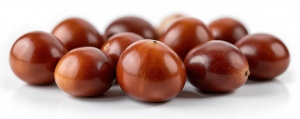 Obraz premium Close-up of several shiny brown chestnuts on white , still life, winter