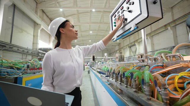Female engineer working at programmable CNC machine in factory industries