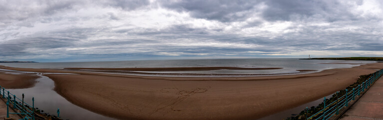 Grey clouds over the expansive beach at Montrose in Angus, Scotland