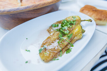 Golden Fried Peppers Topped with Fresh Parsley and Coarse Sea Salt, Served on a White Plate