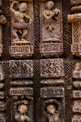 A close-up view of detailed stone carvings on the wall of Konark sun temple, an ancient temple.