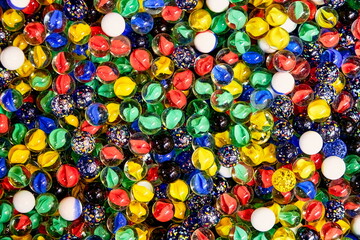 a bucket full of colourful glass balls