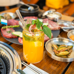 Refreshing Orange Mocktail with Korean BBQ Platter