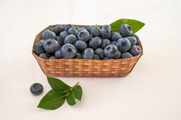 Blueberries in a paper container with a basket pattern. Close-up. Soft focus.