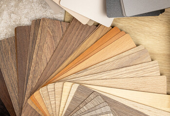 Samples of laminated chipboard. A range of gray and brown shades of wood-like boards. Concept of interior design and decor.