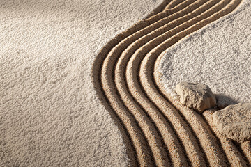 Spa or zen background. Sand with lines and stone