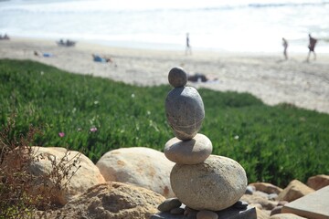 Stacked rocks on the beach in Carlsbad, California.
