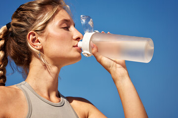 Woman staying hydrated while outdoors on a sunny warm day