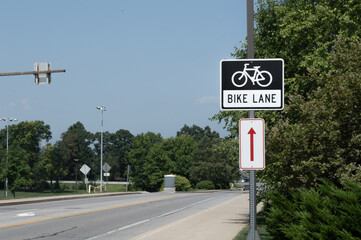 Bike Lane Sign Next to Road on Sunny Day
