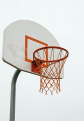 Naklejka premium Outdoor Basketball Hoop Against a Cloudy Sky