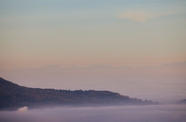 Fototapeta premium Serene mountain landscape at dawn with mist.