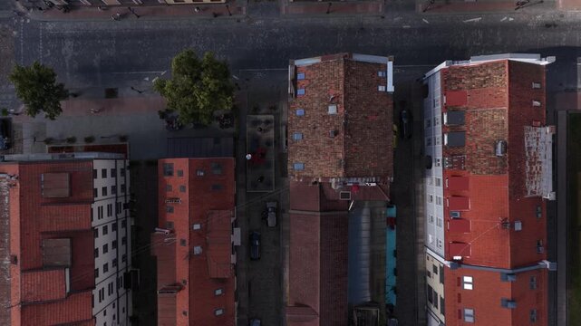 Aerial vertical view of Klaipėda Old Town, Lithuania, showing cobblestone streets, red-tiled rooftops, historic buildings, and outdoor seating areas along narrow pedestrian-friendly lanes.