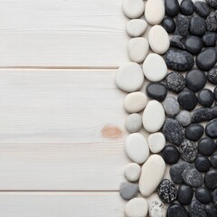 Smooth stones arranged on a light wood surface