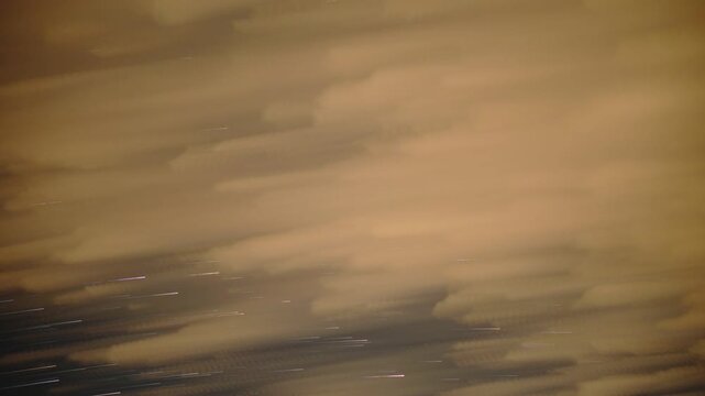 Stars and clouds nightscape timelapse under a light polluted sky