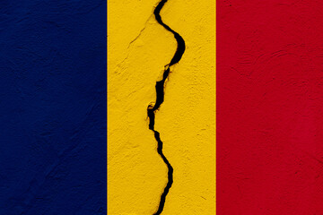 The flag of the Republic of Chad into a grunge cracked wall.