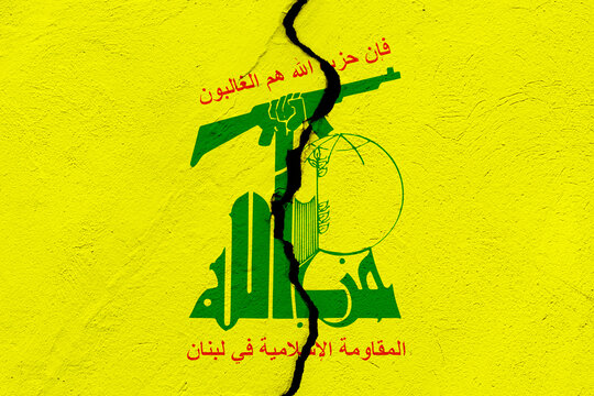 The flag of Hezbollah paramilitary group into a grunge cracked wall