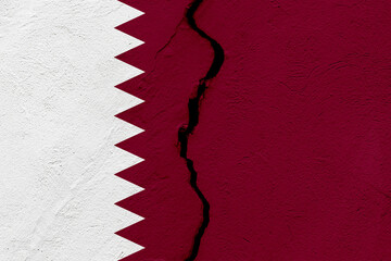 The flag of the State of Qatar into a grunge cracked wall