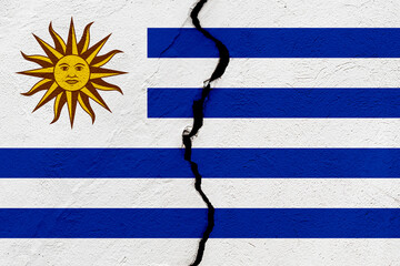 The flag of the Republic East of the Uruguay into a grunge cracked wall